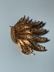 Vintage Monet Gold Tone Textured Peacock Filigree Brooch