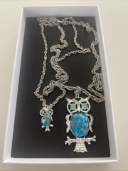 Vintage-style silver-tone owl pendant featuring a faux turquoise