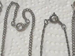 Lot of silver tone chain necklaces with rhinestone pendants. Coin, Love + Luck
