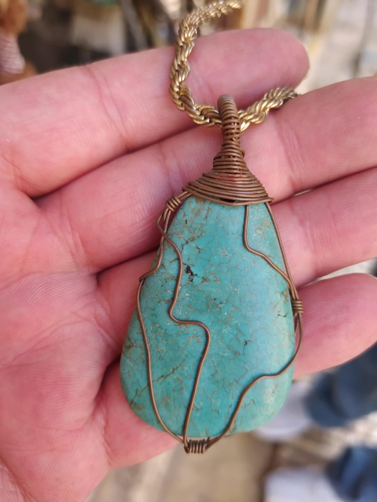 A braided red copper necklace a medium-sized, rare pear-shaped pure turquois