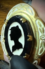 Antique Victorian gold and white colored brooch with black and white glass cameo