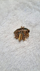 Vintage white flower and green leaf with pearl pendant, gold accents