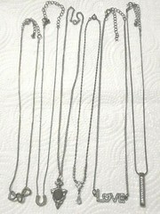 Lot of silver tone chain necklaces with rhinestone pendants. Coin, Love + Luck