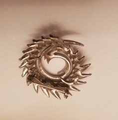 Silver-Tone Spiral Brooch Features A Brushed Feather Design