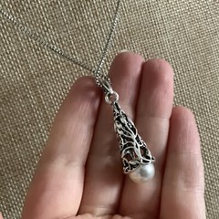 Faux pearl filigree cone necklace in silver tone metal on box chain