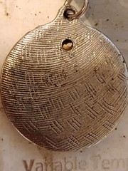 vintage 8545 charm.It is designed as a round textured metal meant to