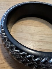 BLACK ACRYLIC LUCITE BANGLE WITH ENCASED SILVERTONE CHAINS
