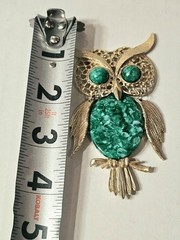 vintage articulated owl pendant necklace features a gold-tone finish, green faux