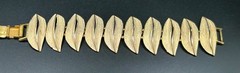 VINTAGE ART ARTHUR PEPPER BRACELET GOLD TONE WITH WHITE FOLD OVER CLASP SIGNED