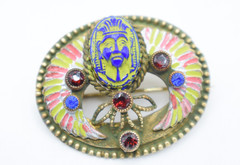 Antique Egyptian Revival winged scarab brooch featuring vibrant enamel work