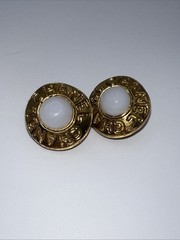 Vintage CHANEL golden round shape faux pearl earrings with cutout logo. Clip On