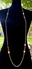 vintage-style necklace features amber-colored barrel beads and gold-tone chain