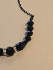vintage-style beaded necklace black faceted beads and silver-toned spacers.