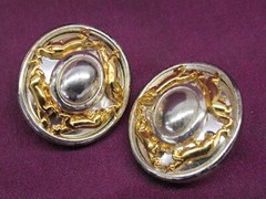 Pair vintage Jackie Collins gold and silver tone oval clip on earrings
