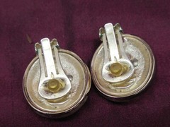 Pair vintage Jackie Collins gold and silver tone oval clip on earrings