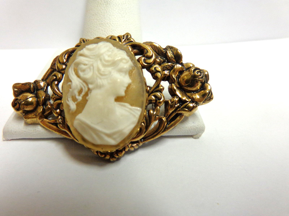 vintage gold tone cameo pin in floral frame sz 2 in wide wgt 9.6 grams girl bust