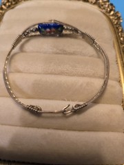 Mexico Alpaca silver hinged bangle bracelet featuring a colorful enameled flower