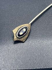 Antique Victorian gold tone stick pin purple glass faceted stone scroll design