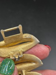 VINTAGE ART ARTHUR PEPPER BRACELET GOLD TONE WITH WHITE FOLD OVER CLASP SIGNED