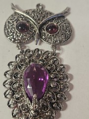 a Rare 1970s Articulated Owl Pendant featuring purple faux-amethyst glass…