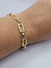 Vintage gold-tone clamper bracelet with an openwork square link design 8.5in