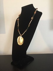 Shell Pendant on a Green, Gold, and Tan Necklace – 25.25 in.