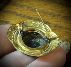 Antique Victorian gold and white colored brooch with black and white glass cameo
