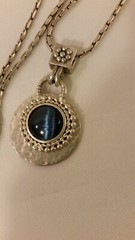 Blue Tiger Eye Cabochon style pendant with a convex formed silver toned reverse