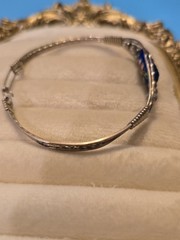 Mexico Alpaca silver hinged bangle bracelet featuring a colorful enameled flower