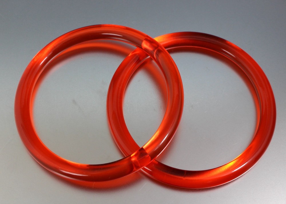 LOT OF 2 VINTAGE ORANGE PLASTIC LUCITE BANGLE BRACELETS