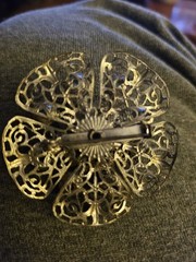 VTG Brooch featuring blue rhinestones set in a silver-tone filigree metal.