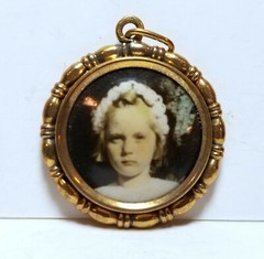 Little girl flowers in hair, photo pendant, c. 1920s, hand colored/tinted