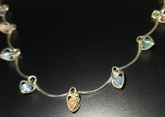 9 multicolor heart caged bead charms on a silvertone necklace